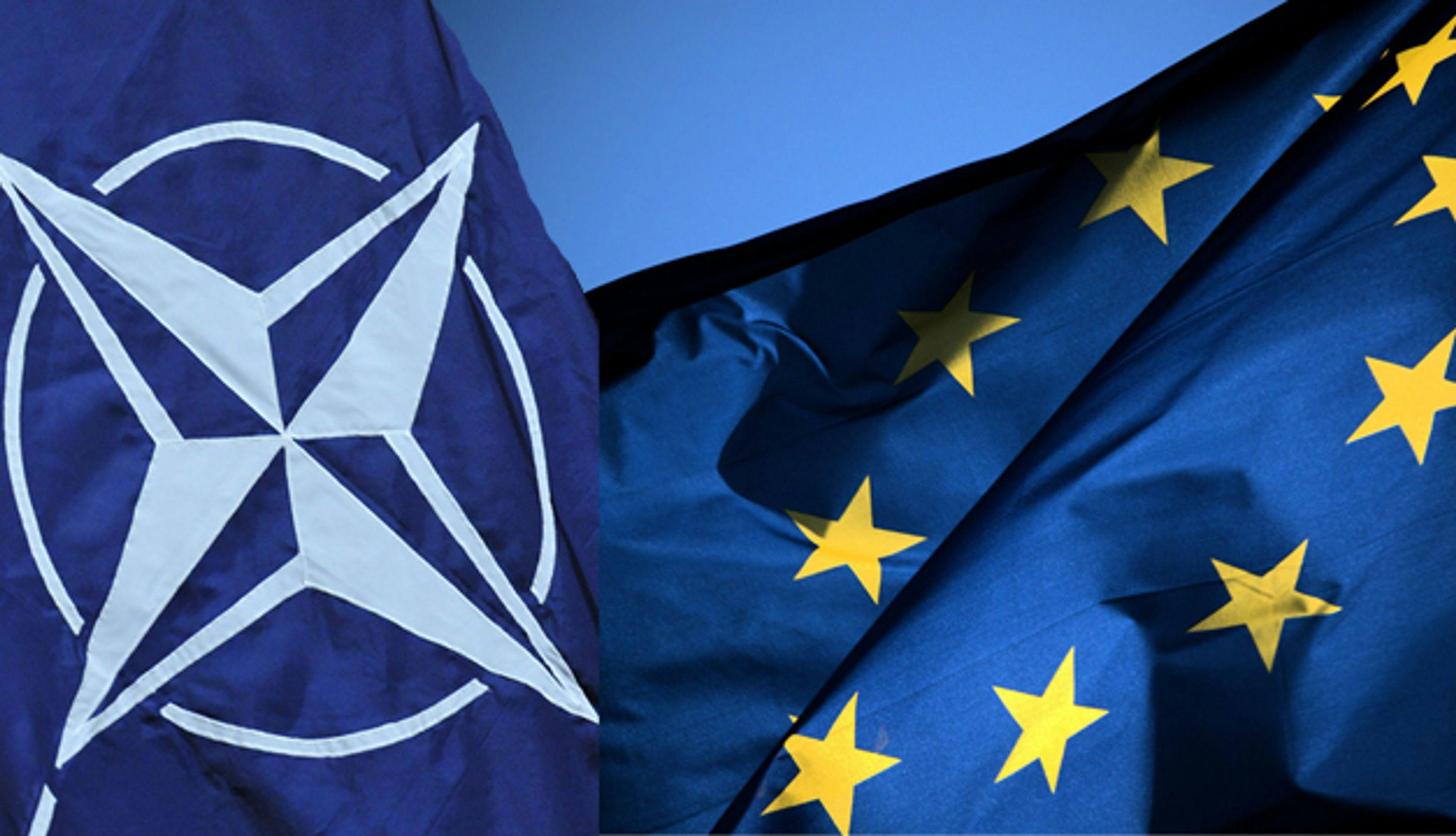 NATO-flagg og EU-flagg som vaier i vinden.